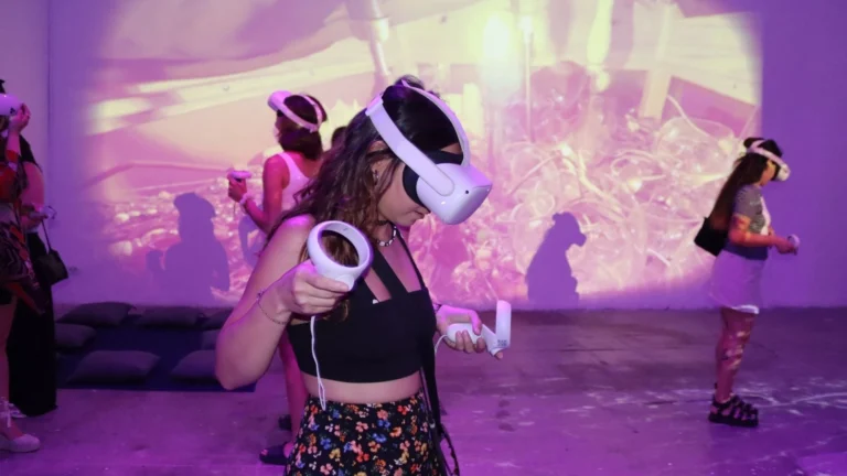 Visitor wearing a VR headset exploring Spinning in Fluid Dreams