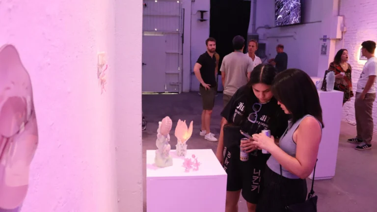 Visitors observing translucent sculptures at the Spinning in Fluid Dreams opening